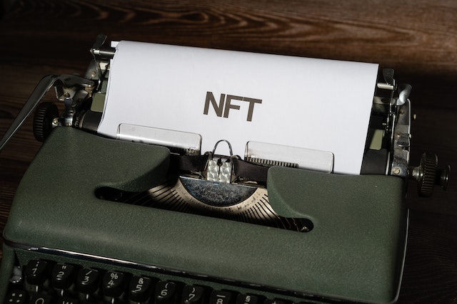 typewriter with NFT on paper